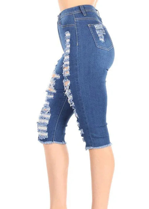 Blue denim capri jeans with distressed details on a white background