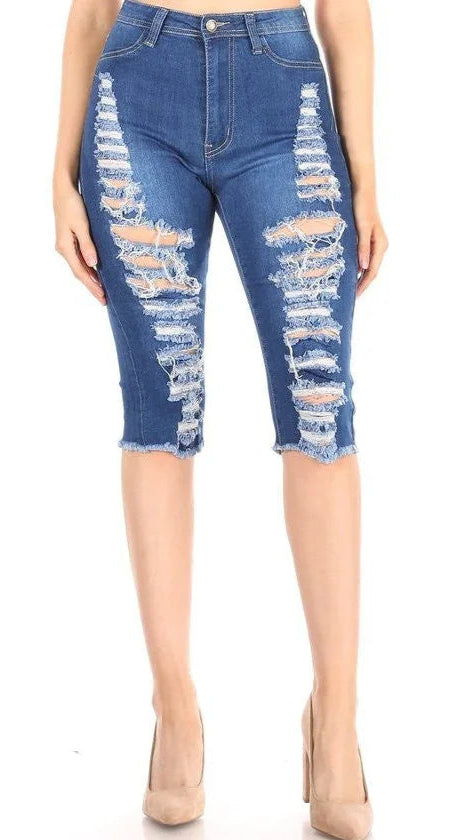 Distressed blue denim capri pants on a white background