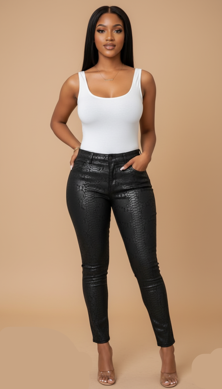 Woman wearing a white tank top and black leather pants against a beige background