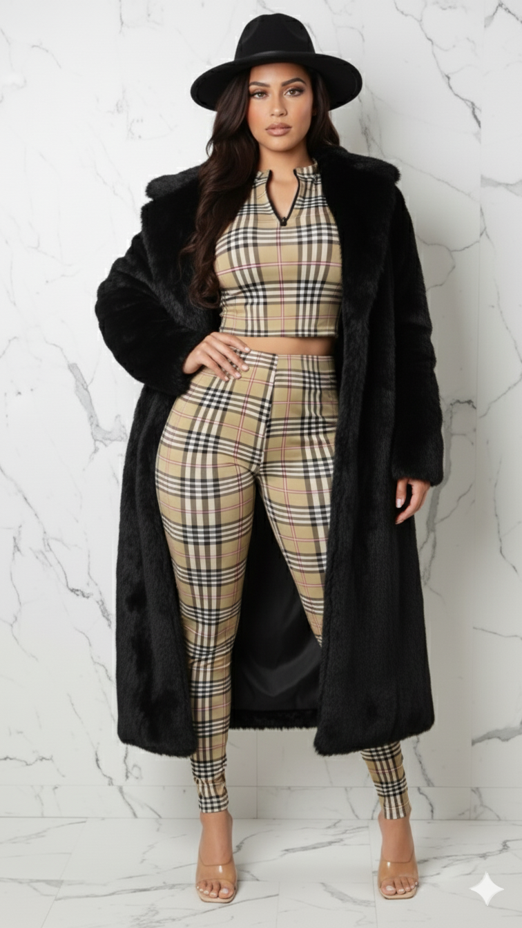 Woman wearing a plaid outfit with a black coat and hat on a white marble background